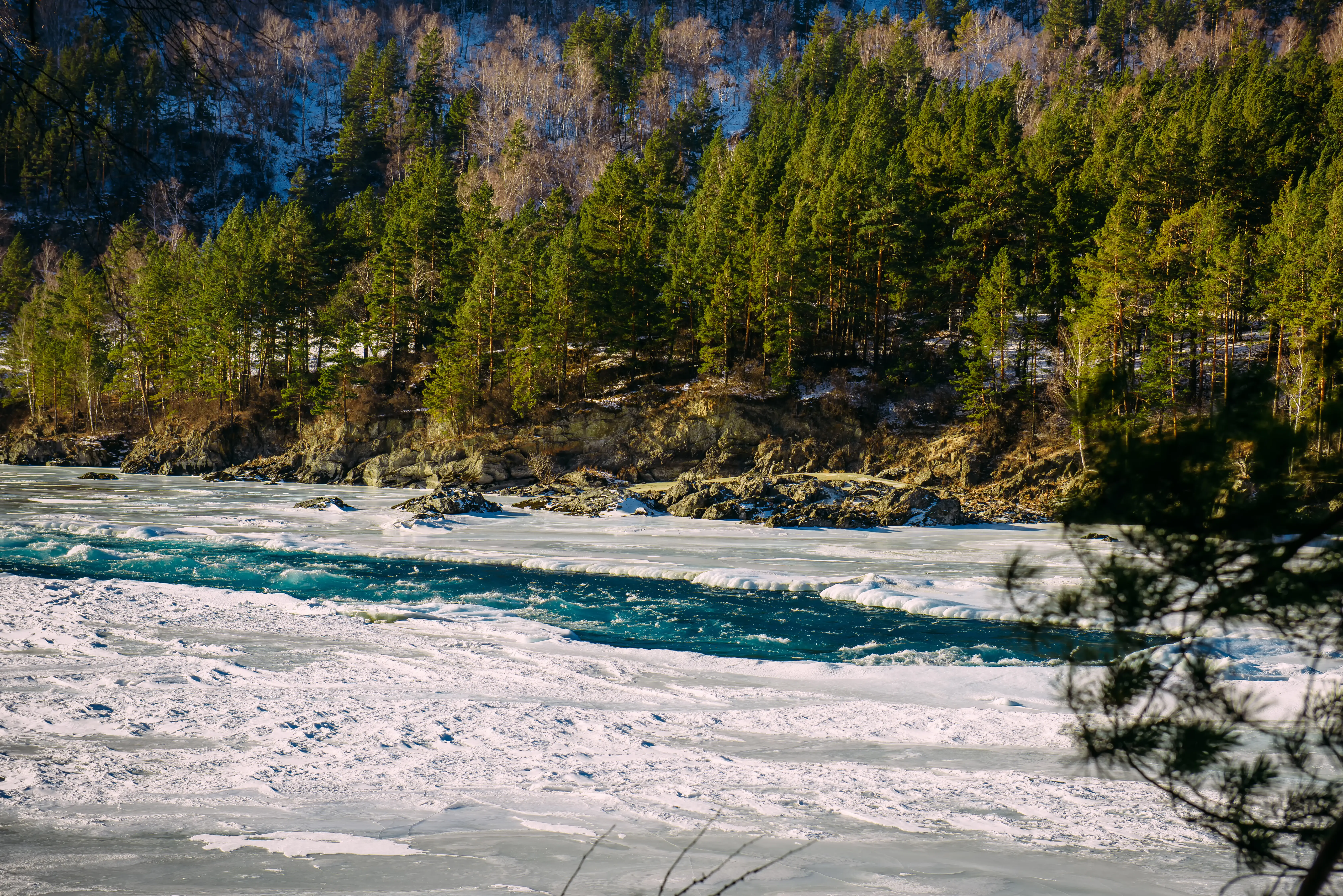 A winter landscape in a mountain river valley